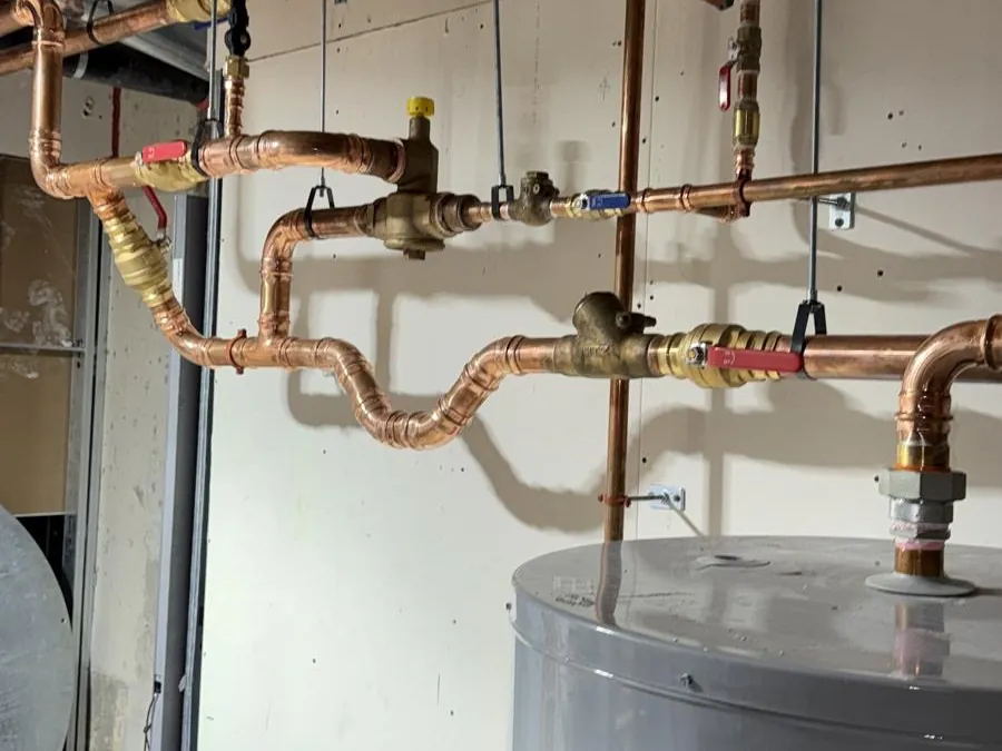 Copper pipework above a tank water heater, installed by A1 Plumbing.