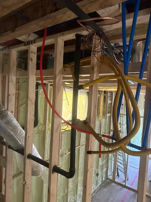 Supply, drain and gas lines run through a basement.