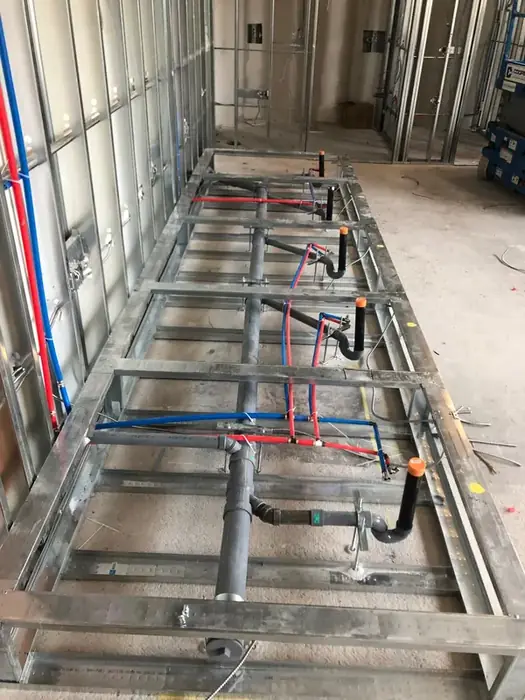 Rough in for a run of bathrooms before the walls go up.