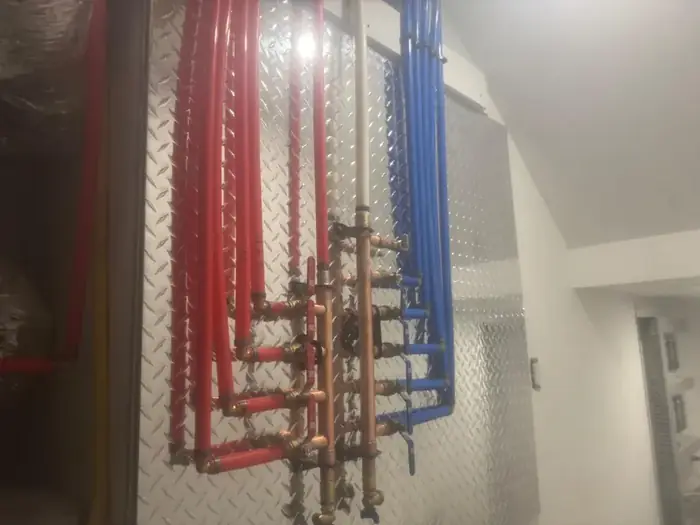 A PEX manifold with the hot and cold runs separated.